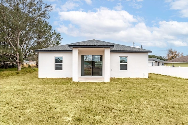 rear view of property with a lawn