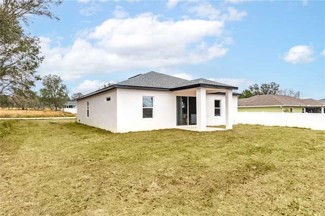 back of house with a lawn