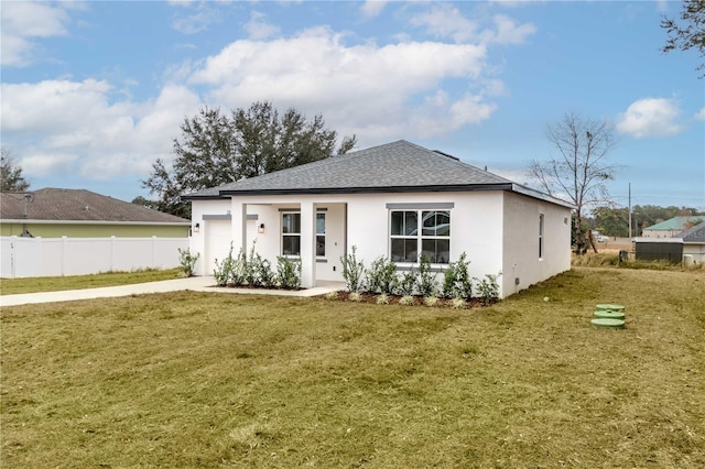 back of property with a yard and a garage