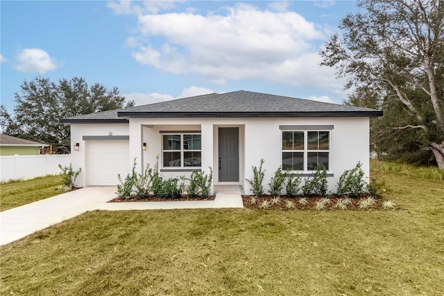 view of front of house with a front yard and a garage