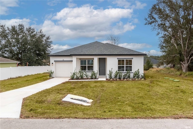 view of front of house featuring a garage and a front lawn