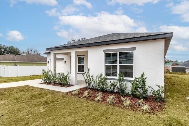 exterior space with a front yard and a garage