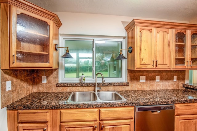 kitchen featuring decorative backsplash, dishwasher, and sink