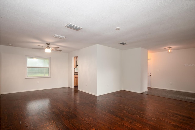 unfurnished room featuring dark wood-type flooring, a textured ceiling, and ceiling fan