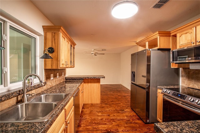 kitchen with tasteful backsplash, light brown cabinetry, dark hardwood / wood-style floors, sink, and stainless steel appliances