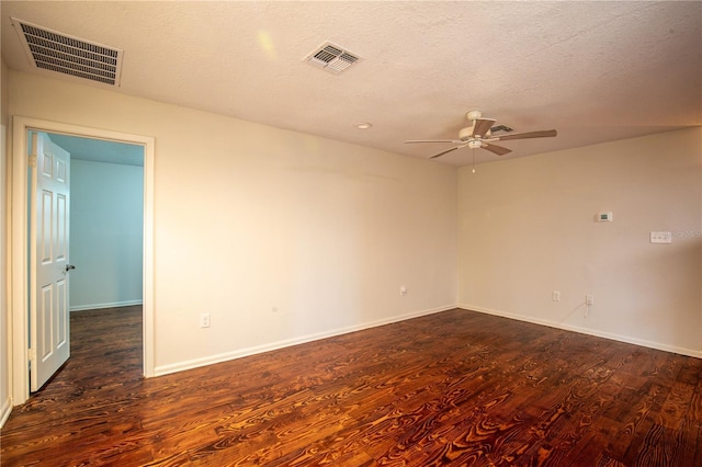 empty room featuring ceiling fan, a textured ceiling, and dark hardwood / wood-style flooring