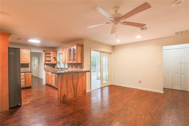 kitchen featuring stainless steel refrigerator, decorative backsplash, sink, and dark hardwood / wood-style flooring