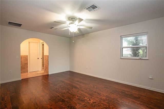 unfurnished room featuring a textured ceiling, ceiling fan, and dark hardwood / wood-style flooring