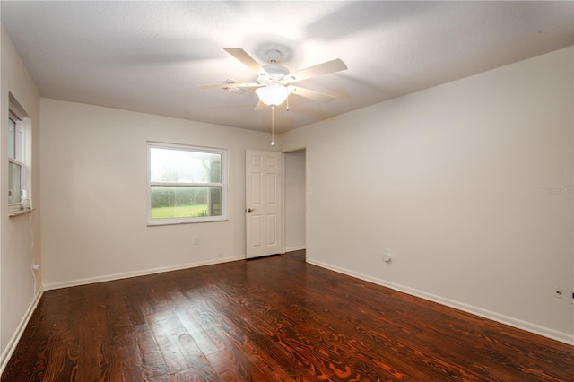 spare room featuring ceiling fan and dark hardwood / wood-style floors