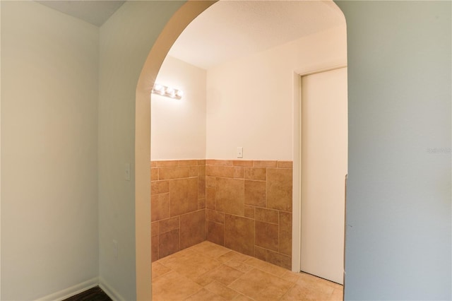 bathroom with tile walls and tile patterned floors