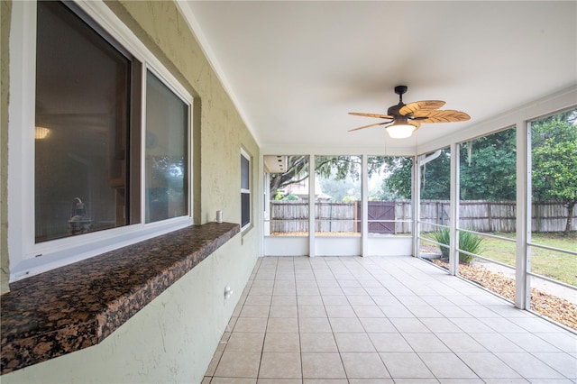 unfurnished sunroom with ceiling fan