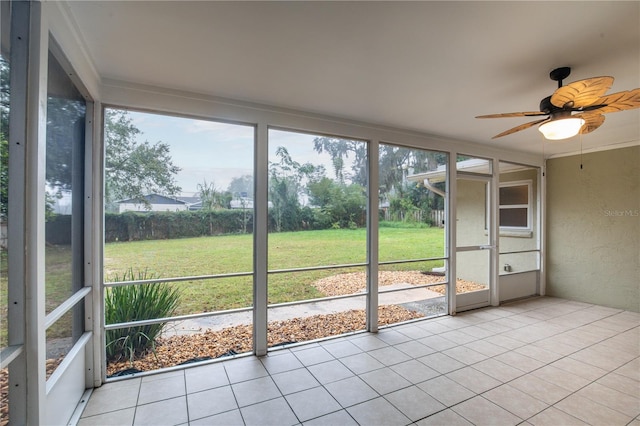 unfurnished sunroom with ceiling fan