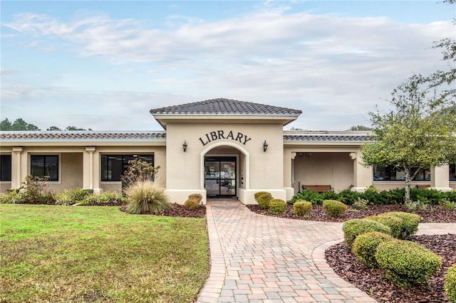 mediterranean / spanish house with a front yard