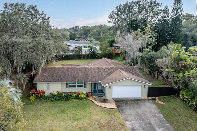 view of front of house with a front yard and a garage