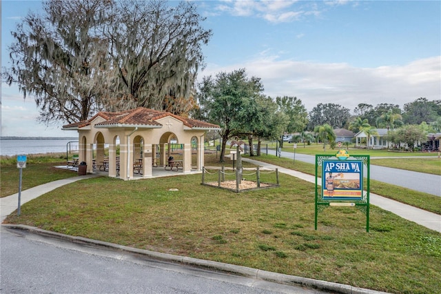 view of community with a yard and a water view