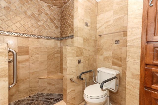 bathroom with a tile shower and toilet