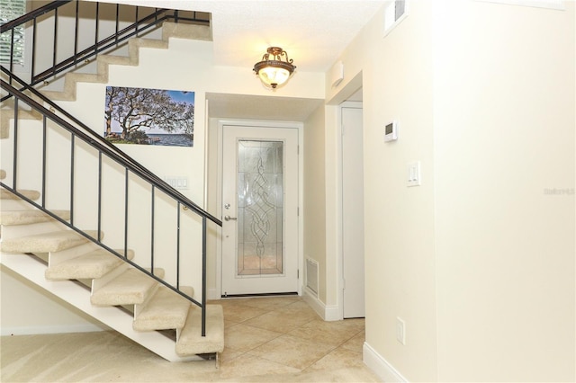 entryway with light tile patterned floors