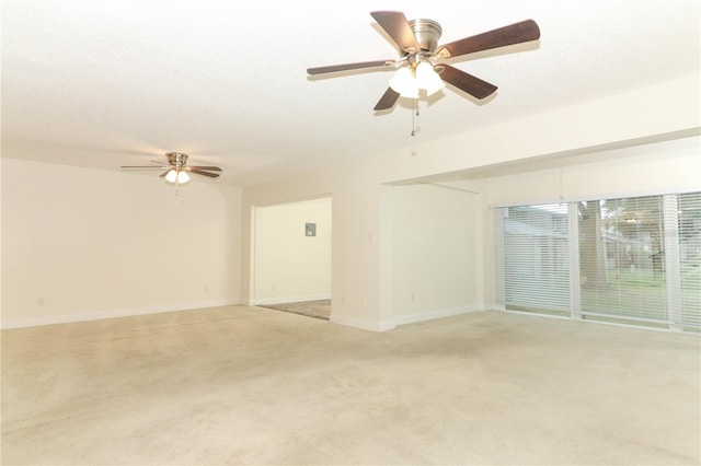 unfurnished room with a textured ceiling, light colored carpet, and ceiling fan