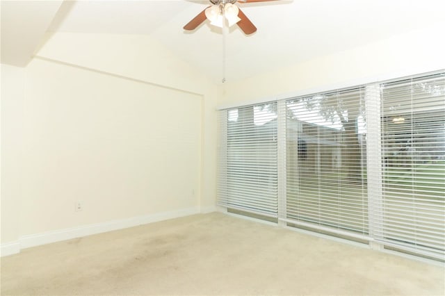 unfurnished room with light carpet, plenty of natural light, ceiling fan, and lofted ceiling