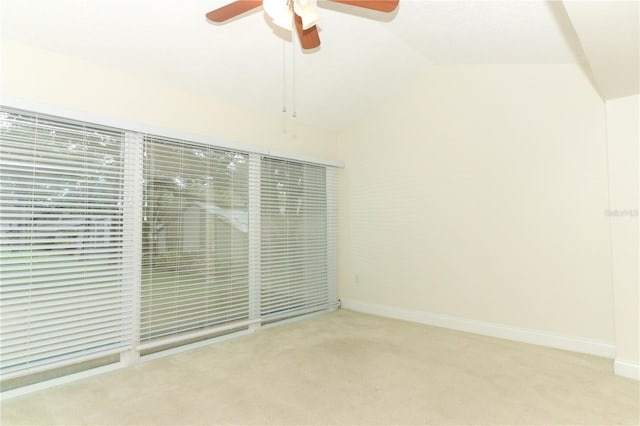 interior space featuring ceiling fan, light colored carpet, and vaulted ceiling