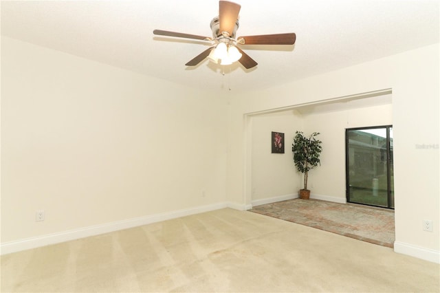 carpeted empty room featuring ceiling fan