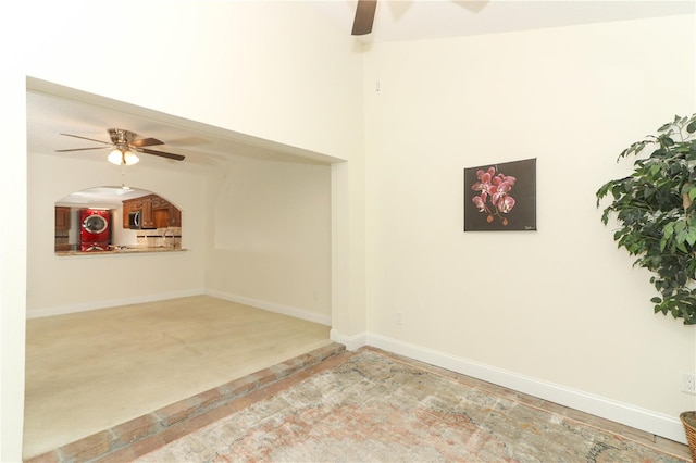 spare room with carpet flooring and ceiling fan