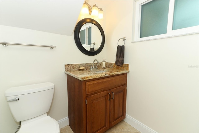 bathroom featuring tile patterned flooring, vanity, and toilet