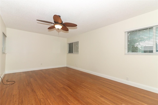 spare room featuring ceiling fan, wood-type flooring, and a textured ceiling