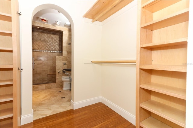 spacious closet featuring hardwood / wood-style flooring