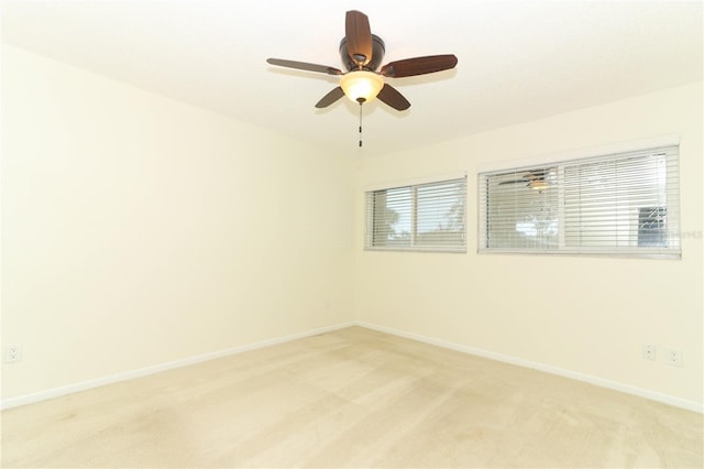 unfurnished room with plenty of natural light, ceiling fan, and light colored carpet