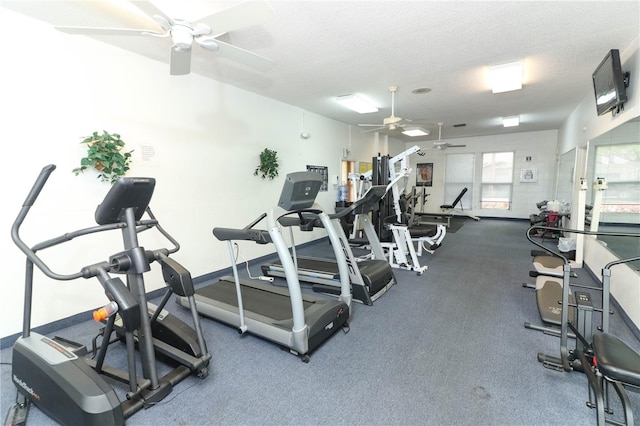 workout area with ceiling fan and a textured ceiling