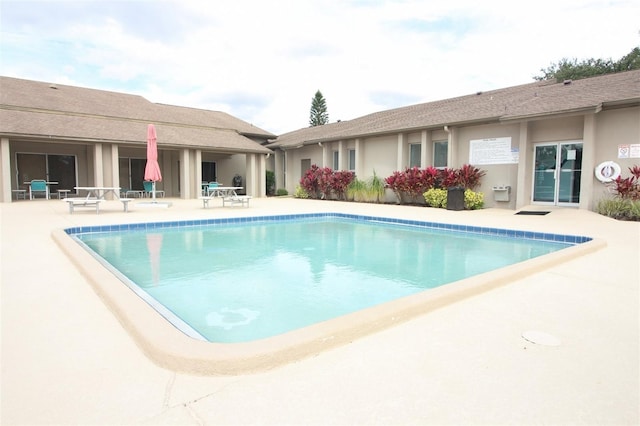 view of swimming pool with a patio area