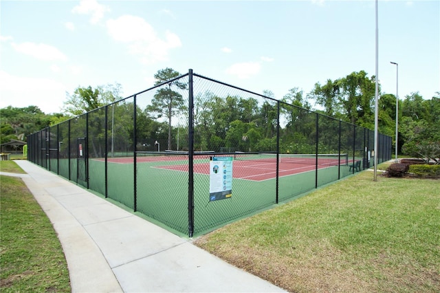 view of sport court featuring a yard