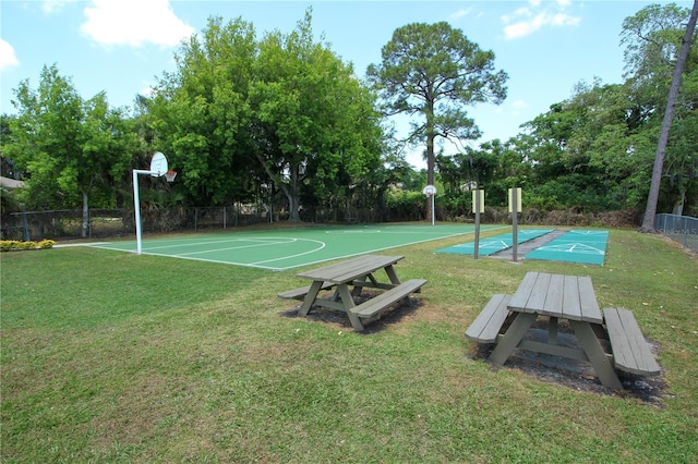 view of sport court featuring a lawn