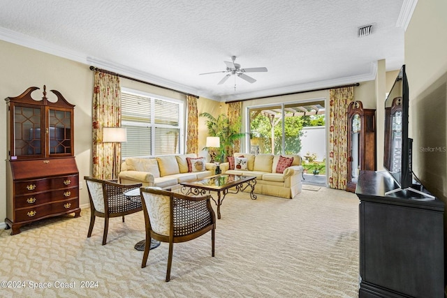 living room featuring crown molding, a textured ceiling, light colored carpet, and ceiling fan