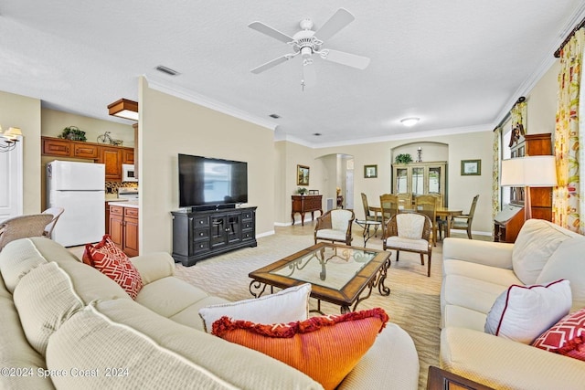 carpeted living room featuring crown molding, a textured ceiling, and ceiling fan