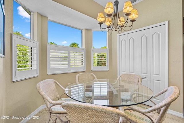 dining area featuring tile patterned flooring and a chandelier