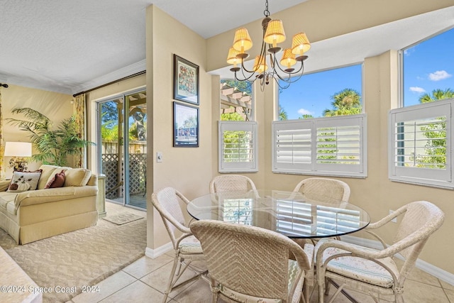 dining space with light tile patterned floors, an inviting chandelier, and plenty of natural light