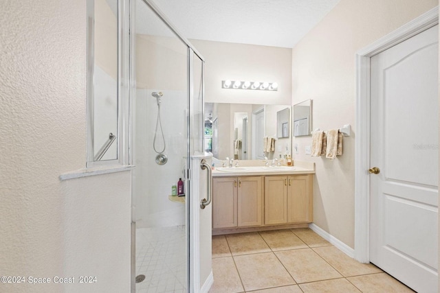 bathroom featuring vanity, walk in shower, and tile patterned flooring