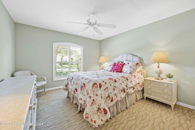 bedroom with light colored carpet and ceiling fan