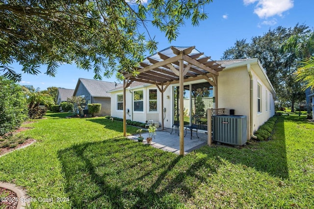 rear view of house featuring a pergola, a patio area, a lawn, and central AC unit