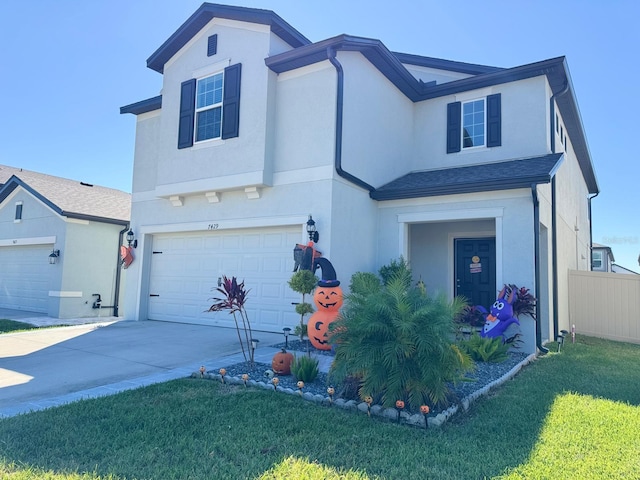 view of front of home with a front lawn and a garage