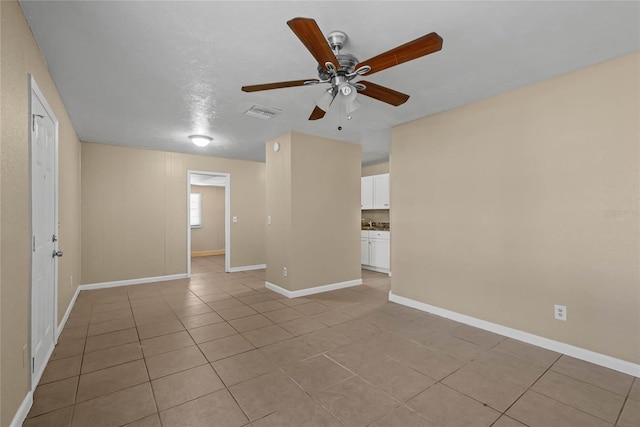 spare room with light tile patterned flooring and ceiling fan