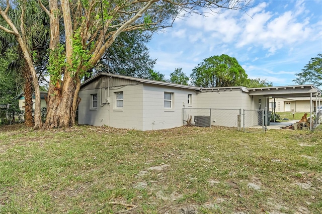 back of property with a lawn