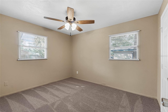 empty room with ceiling fan and carpet