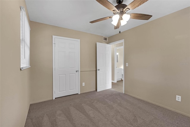 unfurnished bedroom featuring light colored carpet and ceiling fan