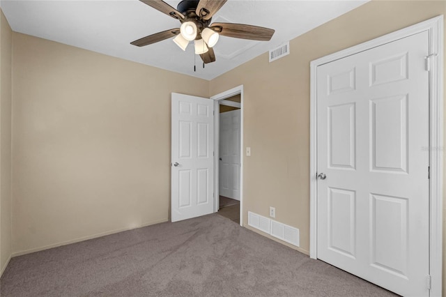 unfurnished bedroom with ceiling fan, a closet, and light colored carpet