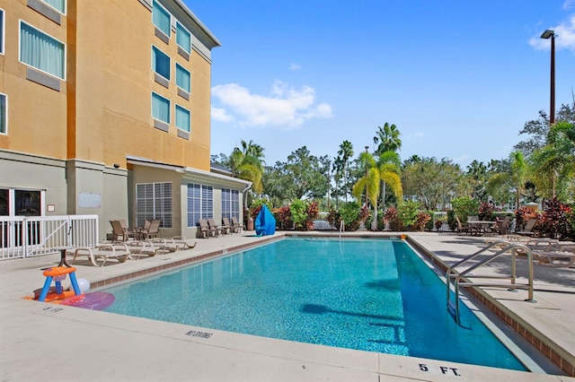 view of swimming pool with a patio