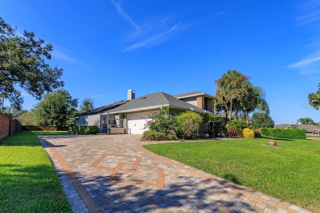 view of front of property featuring a garage and a front lawn