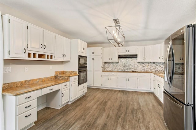 kitchen with light stone counters, black appliances, pendant lighting, and white cabinets